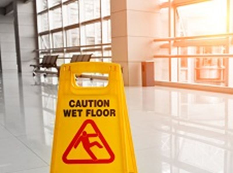 A yellow sign that says caution, wet floor